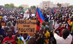 FILE - Nigeriens participate in a march called by supporters of coup leader Gen. Abdourahmane Tchiani in Niamey, Niger, Sunday, July 30, 2023. The French troops being forced out of Niger were seen as a key line of decadelong defense amid efforts led by the West, particularly U.S. and France, to fight against jihadi violence in Africa’s hard-hit Sahel region. The sign reads: "Down with France, long live Putin." (AP Photo/Sam Mednick, File)