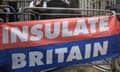 An Insulate Britain banner next to a metal barrier