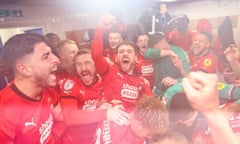 Leyton Orient players get their celebrations on, luckily with the power on again.
