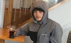 Saul Cookson, a teenager in a hooded anorak posing for the photo with a drink in a glass