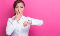 Portrait Of Surprised Businesswoman Checking Time While Standing Against Pink Background