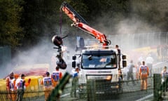 Parts of the wreckage of Juan Manuel Correa’s Sauber are removed from the track at Spa after the fatal collision last Saturday.