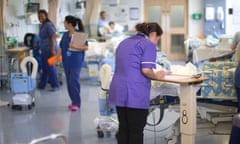 A nurse at a workstation in an NHS hospital ward