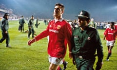 Eric Cantona is escorted from the pitch after he was sent off at the end of the match against Galatasaray in November 1993. Manchester United drew 0-0 and went out on away goals