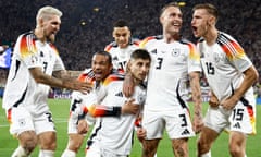 Kai Havertz is embraced by his Germany teammates