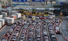 Cars and trucks lined up across several lanes of roadway