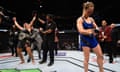 Amanda Nunes of Brazil (left) reacts to her victory over Ronda Rousey (right) in their UFC women's bantamweight championship bout during the UFC 207 event at T-Mobile Arena on December 30, 2016 in Las Vegas, Nevada.  (Photo by Jeff Bottari/Zuffa LLC/Zuffa LLC via Getty Images)