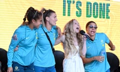 Matildas Mary Fowler, Steph Catley and Sam Kerr sing their unofficial team anthem Strawberry Kisses with Nikki Webster at a community reception in Brisbane. 