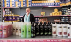 Jackie Knox standing in a storeroom stocked with food and other products