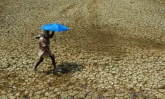 A villager walks over parched land on the outskirts of Bhubaneswar, India in 2009.