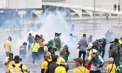 TOPSHOT-BRAZIL-POLITICS-BOLSONARO-SUPPORTERS-DEMONSTRATION<br>TOPSHOT - Supporters of Brazilian former President Jair Bolsonaro clash with the police during a demonstration outside the Planalto Palace in Brasilia on January 8, 2023. - Brazilian police used tear gas Sunday to repel hundreds of supporters of far-right ex-president Jair Bolsonaro after they stormed onto Congress grounds one week after President Luis Inacio Lula da Silva's inauguration, an AFP photographer witnessed. (Photo by EVARISTO SA / AFP) (Photo by EVARISTO SA/AFP via Getty Images)