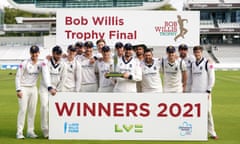 Warwickshire captain Will Rhodes holds the trophy aloft with his team at Lord’s.