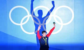 Michael Phelps of the United States celebrates on the podium.