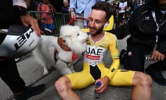 Adam Yates is greeted by his pet dog Zoe after crossing the finish line at Villars-sur-Ollon.
