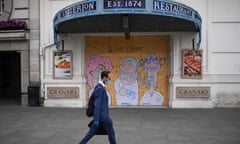 BRITAIN-HEALTH-VIRUS-ECONOMY<br>A man wearing a face mask walks past a boarded up restaurant near Piccadilly Circus in London’s main high street shopping area on May 22, 2020 as lockdown restrictions to combat the spread of the novel coronavirus remain in place. - UK retail sales dived by a record 18.1 percent in April with the country in coronavirus lockdown, triggering a surge in government borrowing to an unprecedented level, data showed on May 22. (Photo by DANIEL LEAL-OLIVAS / AFP) (Photo by DANIEL LEAL-OLIVAS/AFP via Getty Images)