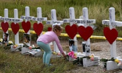 Shaelyn Gisler,4, prepares to leave flowers on crosses named for the victims outside the First Baptist Church, which was the scene of the mass shooting that killed 26 people in Sutherland Springs, Texas on November 9, 2017. Willeford shot suspect Devin Patrick Kelley, a gunman wearing all black armed with an assault rifle that opened fire on a small-town Texas church during Sunday morning services, on November 5, killing 26 people and wounding 20 more in the last mass shooting to shock the United States. / AFP PHOTO / MARK RALSTONMARK RALSTON/AFP/Getty Images
