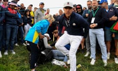 Brooks Koepka checks on Corine Remande after she was struck by his ball.