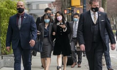 Meng Wanzhou, center right, chief financial officer of Huawei, walks down the street with an acquaintance after leaving British Columbia Supreme Court during a lunch break at her extradition hearing, in Vancouver on Thursday, April 1, 2021. (Rich Lam/The Canadian Press via AP)