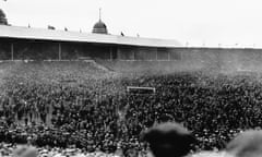 The crowd spills on to the pitch during the 1923 FA Cup final between Bolton Wanderers and West Ham United.