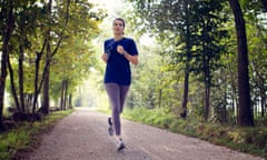 woman running through a woodland