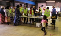 Warruwi residents line up for food at an evacuation centre inside Darwin Showground on March 23, 2015. More than 420 people were brought to Darwin, Australia in an evacuation ahead of tropical cyclone Nathan.
