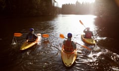 Three people kayaking on a sunny day