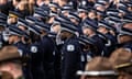 Chicago police officers salute as pallbearers carry the casket for Officer Andres Vasquez Lasso into St. Rita of Cascia Shrine Chapel for his funeral, Thursday, March 9, 2023, in Chicago. Vasquez Lasso, 32, who had nearly five years on the force, was shot and killed March 1 on the Southwest Side as he chased an armed suspect who turned and fired "at close range," police said. (Ashlee Rezin/Chicago Sun-Times via AP)