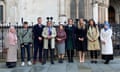 People stand in a line outside the High Court in London