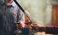 Men tasting wine in cellar