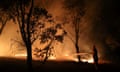 A firefighter works to extinguish flames after a bushfire burnt through the area in Bredbo, New South Wales, Australia, February 2, 2020.