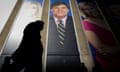 Poster of Tucker Carlson looms over someone walking past Fox News building