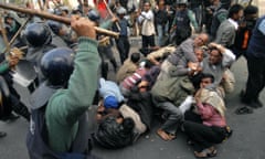 RRiot policemen charge a group of activists in  Dhaka, Bangladesh.