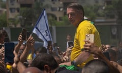 Brazil's former President Jair Bolsonaro is surrounded by supporters after attending a campaign event launching the pre-candidacy of a mayoral candidate, in Rio de Janeiro, Brazil, Saturday, March 16, 2024. (AP Photo/Silvia Izquierdo)