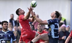 Jersey’s Russell Bennett (left of centre) and Bedford’s Sean French compete for an aerial ball last Saturday