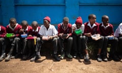 Students eat during a lunch break at Salama primary school in Huruma, Nairobi, on 18 October.