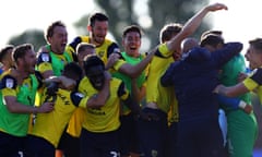 Oxford United players celebrate after Cameron Brannagan’s winning penalty in the semi-final shootout.