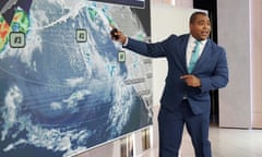 meteorologist pointing at screen