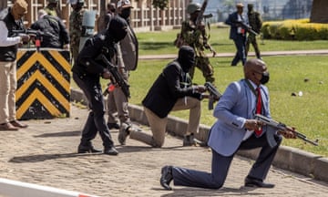 Police officers and security personnel take positions outside the Kenyan parliament during a nationwide protest against the finance bill