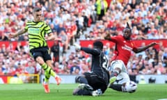 Leandro Trossard of Arsenal scores his team's first goal as Andre Onana of Manchester United and Aaron Wan-Bissaka of Manchester United fail to stop the ball.