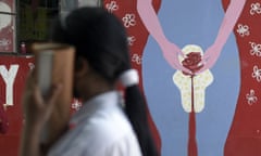 A girl walks past to a wall painting about menstruation, at a school in Guwahati, India, on 28 May 2022. The Menstrual Hygiene Day raises awareness about the importance of managing good menstrual hygiene.