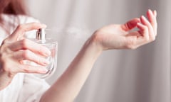 girl sprays herself perfume on her wrist<br>girl in a white dress sprays herself perfume on her wrist