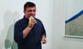 David Datuna removes the piece, Comedian by Maurizio Cattelan, from the wall of the Perrotin gallery at Art Basel in Miami