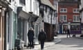People walk up a road in Godalming, Surrey