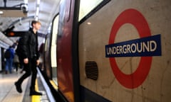 A passenger steps on to a tube train