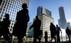 Office workers and commuters walking through Canary Wharf in London. 