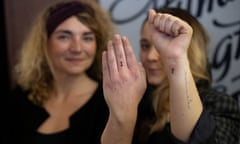 Two women with one-letter tattoos