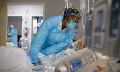 Demetra Ranson, a healthcare worker, comforts a patient in the Covid-19 ward at United Memorial medical center in Houston on 4 December.