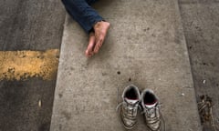 In the shoes of the destitute ... a homeless man sleeps on the street.