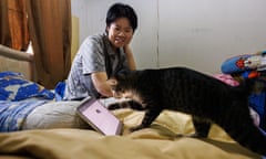 Titapa Thaipreecha plays a cat YouTube channel for her cat in the bedroom of her parents' house in Bangkok, Thailand.