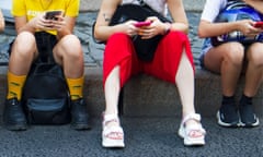 Group of teenagers sitting with phones